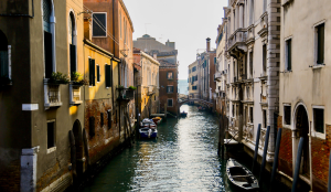Narrow long straight channel in Venice, Italy